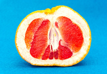Pink ripe half-sliced juicy fresh grapefruit closeup