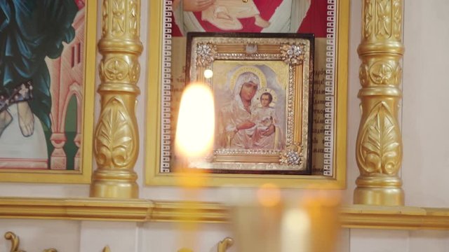 Icon framed with Jesus Christ and the mother of God in the church. Candle is burning