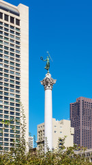 Representation of Nike, the ancient Greek goddess of victory, memorial statue atop the Dewey Monument, situated in the busy square in Union Square, San Francisco, California, US