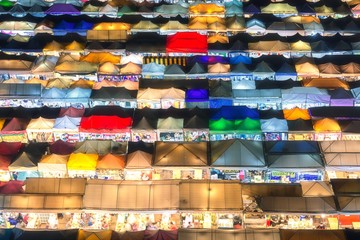 Bangkok, Thailand, Top view of Train Night Market Ratchada (Talad Rot Fai) flea market with plenty of shops with colorful canvas and amazing pattern of roofs near MRT line