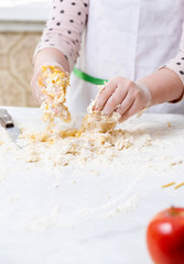 Little girl bakes pies in the kitchen