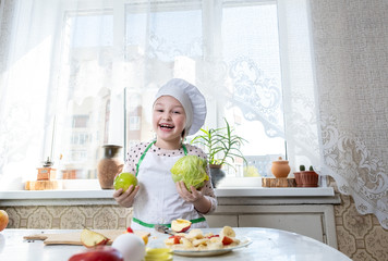 A child in the kitchen playing cook