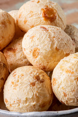 Brazilian cheese bread in a bowl. Wood background.