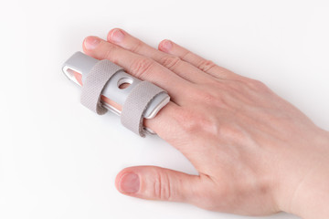 Grey plastic two-sided Finger Splint with two convenient hook-and-loop straps on an broken index finger, holding a finger straight with orthopedic device