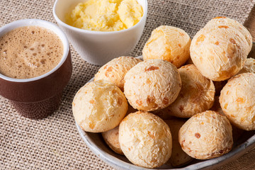 Brazilian cheese bread in a bowl. Wood background.