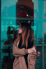 Confident successful business woman in glasses with red lipstick on a blue glass background with a...