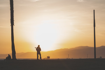 silhouette of a man Standing watching the sunset 