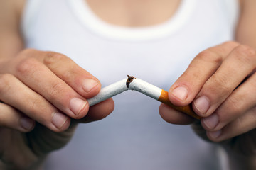 female hands break a cigarette in half close-up. stop smoking, bad habit, harm from smoking and...