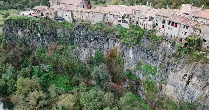Aerial view of Castellfollit de la Roca, medieval Catalan hamlet on cliff on autumn day