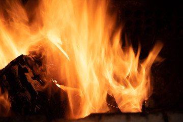 Fire flames on barbecue grill burning raw wood