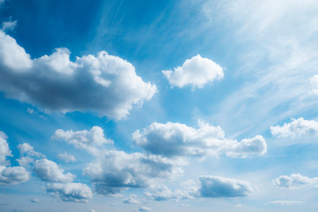 Fluffy white clouds on a blue sky background. Photo of the sky with clouds. Cumulus clouds.