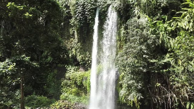 A stunning two levelled waterfall in Lombok, Indonesia. Tiu Kelep Waterfall is surrounded by lush green plants from each side. Long and powerful waterfall. Beauty of the nature.
