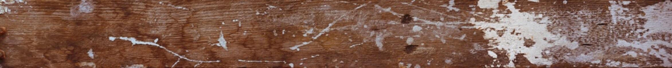 The surface of an old wooden board with stains of paint