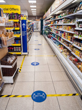 London, Spitalfields, UK. May 14th 2020: Tesco local store, floor signs and warning hazard tape. Shopping lane social distancing, due to coronavirus, Covid-19 outbreak. Keep your distance and queuing.