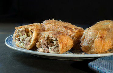 Chinese food, egg rolls on a plate in a Black Background