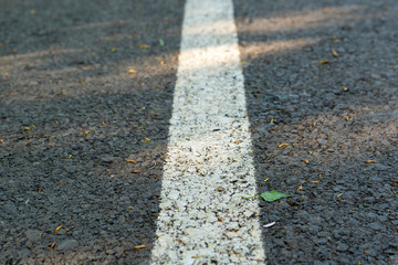 Obraz premium Road with a dividing strip,the concept of movement, gray texture.