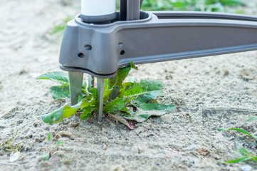 A good example of a weed removal tool. Capture a plant along with a root from the soil.