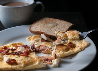 Concept of macro photography, morning food or breakfast, omelet with toast and butter