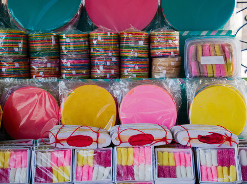 Street stand full with Mexican traditional sweets, colorful wafers known as obleas, dulce de leche or cajeta,  confection of thickened caramel, and borrachitos or tratitional Mexican wine gums