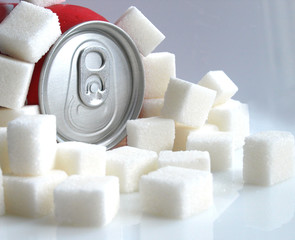softdrink can and sugar cubes over white background