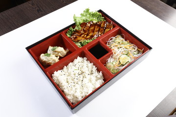 Grilled chicken teriyaki with asian rice, dumpling and oriental salad