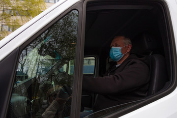 Male driver +50 in a medical mask.