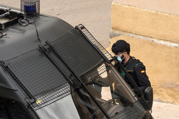 A police officer from the Spanish Civil Guard gets into his police vehicle to set up a checkpoint...