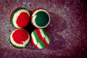 handmade woven juggling balls, grass background