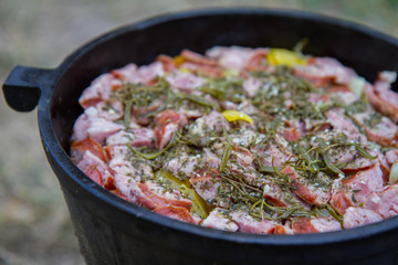 Traditional one pot dish of meat and vegetable done in a cast iron cauldron over a bonfire