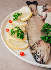 Fresh trout fish with lemon parsley cranberries