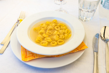 Tortellini in broth close up view