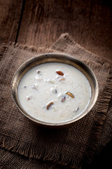 Kheer or Payasam is a type of rice pudding from the Indian subcontinent, made by boiling milk and sugar and is flavoured with dry fruits and nuts, served in metal bowl.