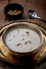 Kheer or Payasam is a type of rice pudding from the Indian subcontinent, made by boiling milk and sugar and is flavoured with dry fruits and nuts, served in metal bowl.