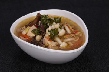 Thai style soup with meat and mushrooms