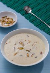 Kheer or Payasam is a type of rice pudding from the Indian subcontinent, made by boiling milk and sugar and is flavoured with dry fruits and nuts, served in ceramic bowl.