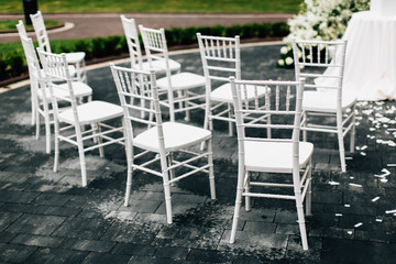 Fototapeta na wymiar White chairs for wedding ceremony