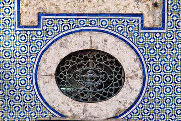 azulejos panel and iron window in Lisbon