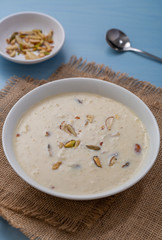 Kheer or Payasam is a type of rice pudding from the Indian subcontinent, made by boiling milk and sugar and is flavoured with dry fruits and nuts, served in ceramic bowl.