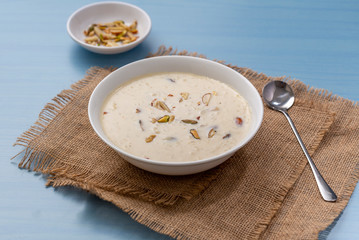Kheer or Payasam is a type of rice pudding from the Indian subcontinent, made by boiling milk and sugar and is flavoured with dry fruits and nuts, served in ceramic bowl.