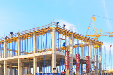 View of the construction site. Tower crane at a construction site. Monolithic frame of the building