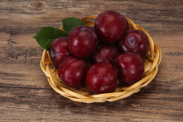 Plum heap in the wooden basket