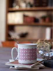 Midcentury modern porcelain cup on books