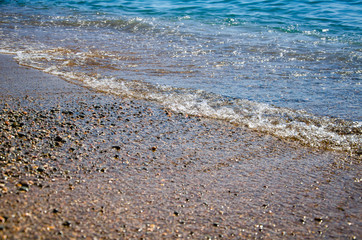 Seascape background colorful stone beach with sea wave