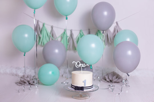 birthday party balloons and white cake