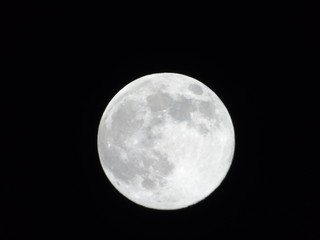 An amazing photography of the full moon over the city of Genova by night with a great clear sky in background and some stars