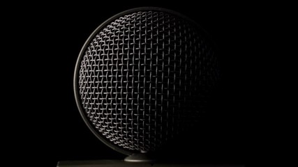 Steel grille background. Shiny metallic dynamic mic grill. The metallic surface of the microphone object.