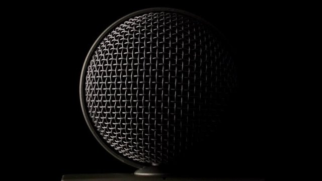 Steel grille background. Shiny metallic dynamic mic grill. The metallic surface of the microphone object.