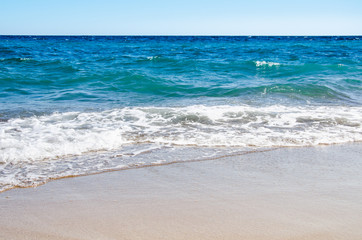 Fototapeta na wymiar Seascape background colorful sea waves on sandy beach