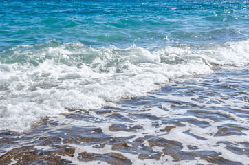 Seascape background white waves on blue sea