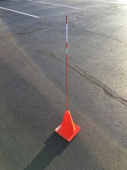 Safety cone in a empty parking lot for maneuverability driving test Practice 
